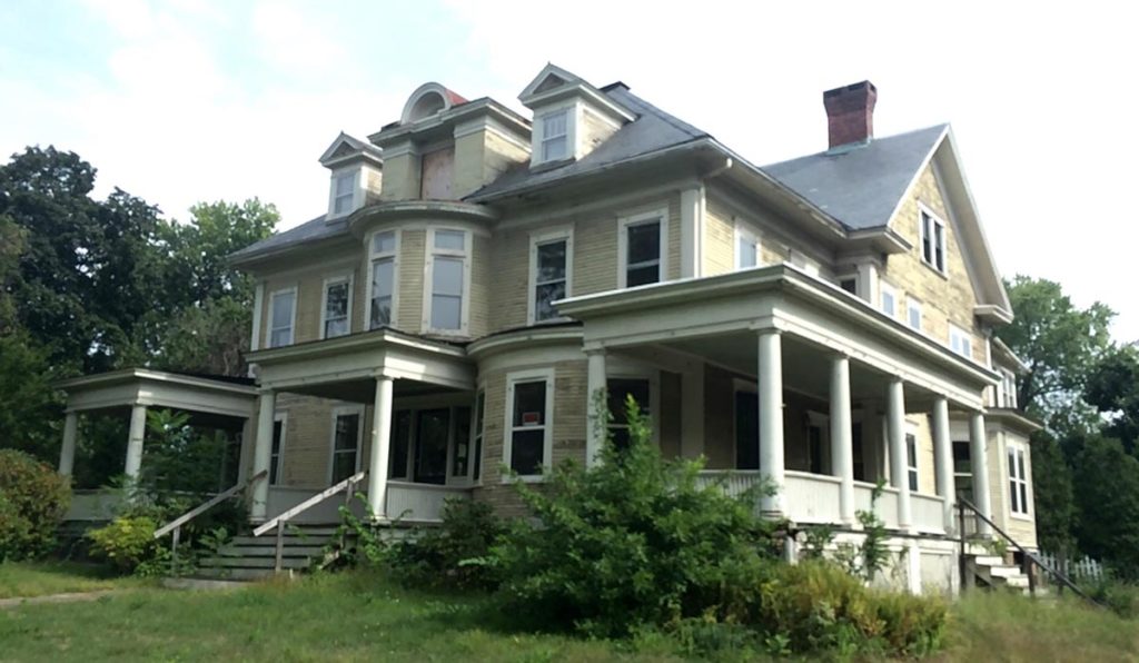 This circa 1900 Four-Square is framed by three sprawling, columned porches, and has bow windows on the first and second floor, along with a Palladian inspired dormer in the center of the roof.